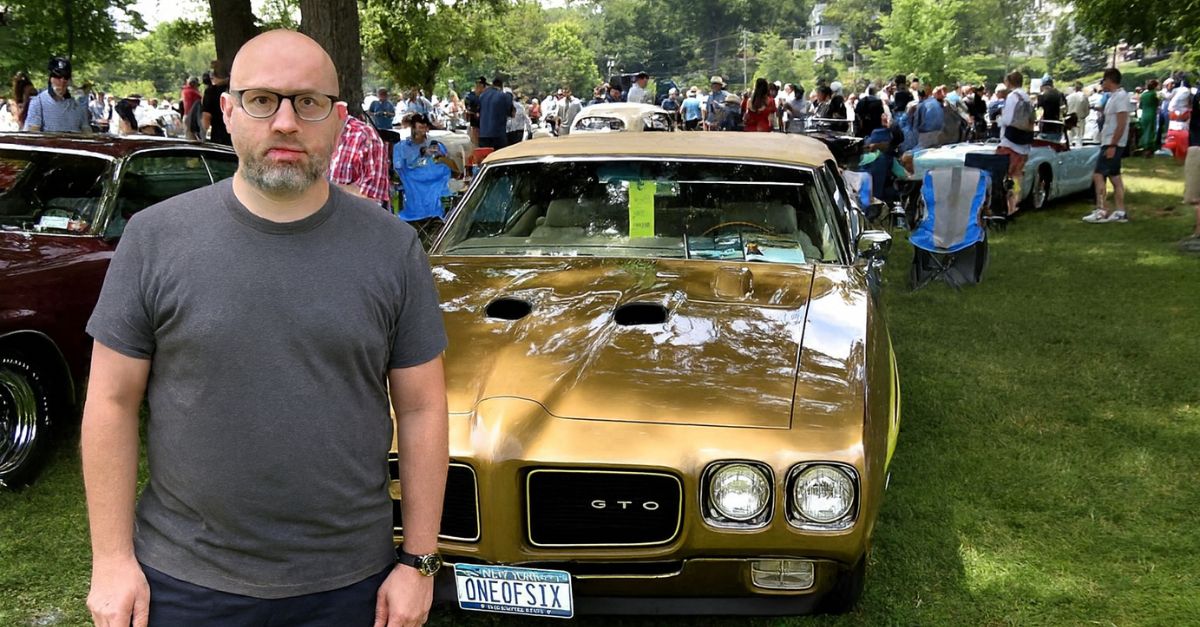 Man standing in front of Pontiac GTO Judge Ram Air IV