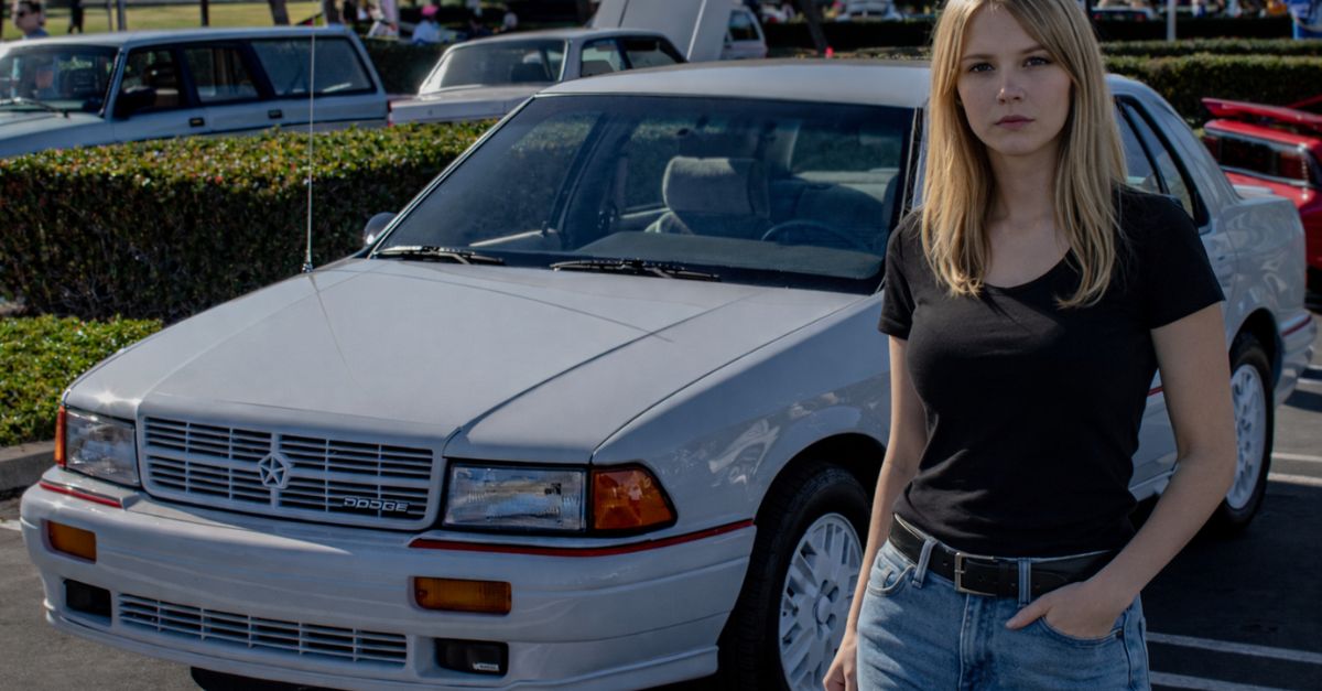 women standing before a car