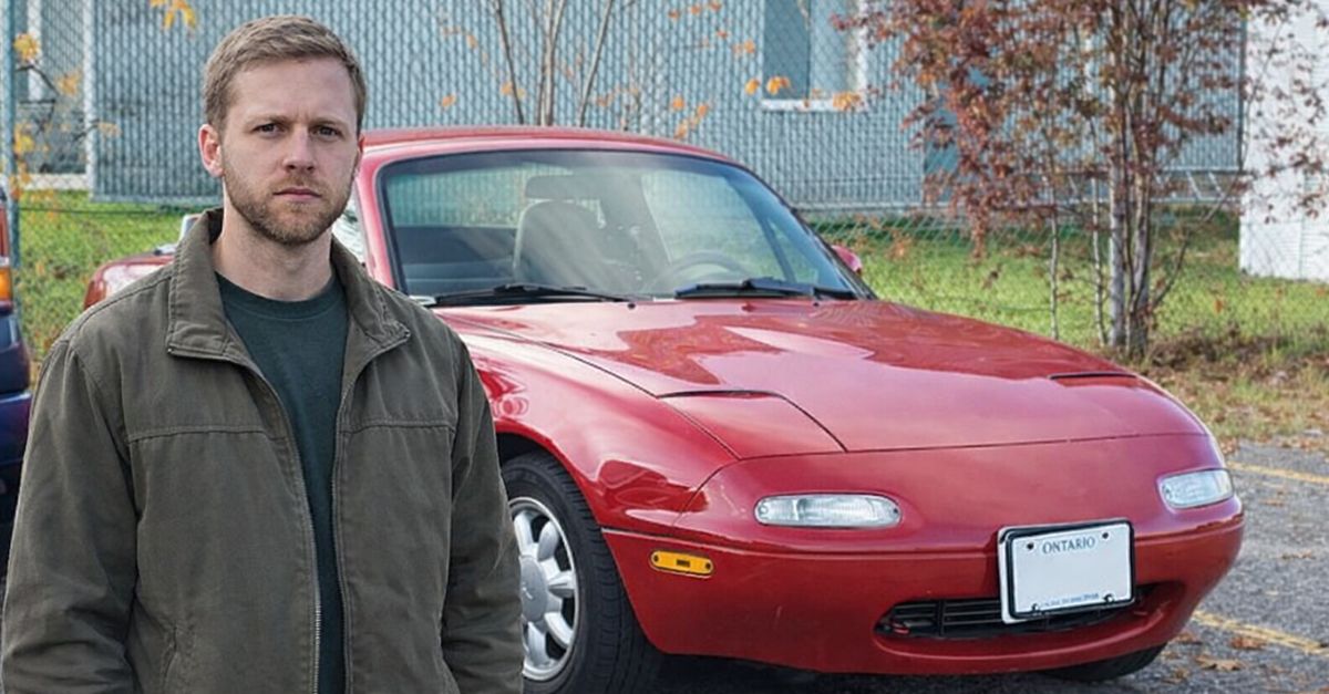 Man standing near a Mazda Miata