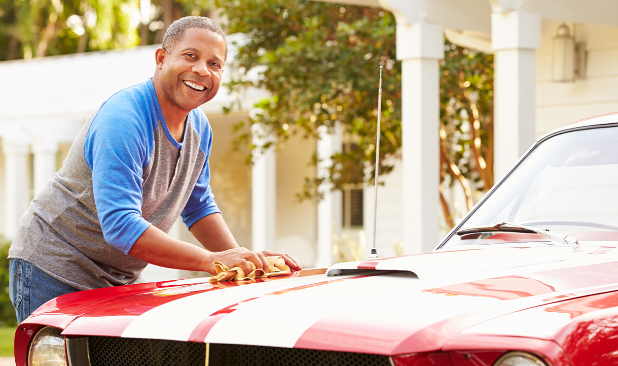 Retired Senior Man Cleaning Restored Car