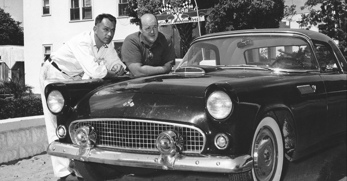 Master mechanic Smokey Yunick (L) poses with automotive journalist Tom McCahill next to a Ford Thunderbird