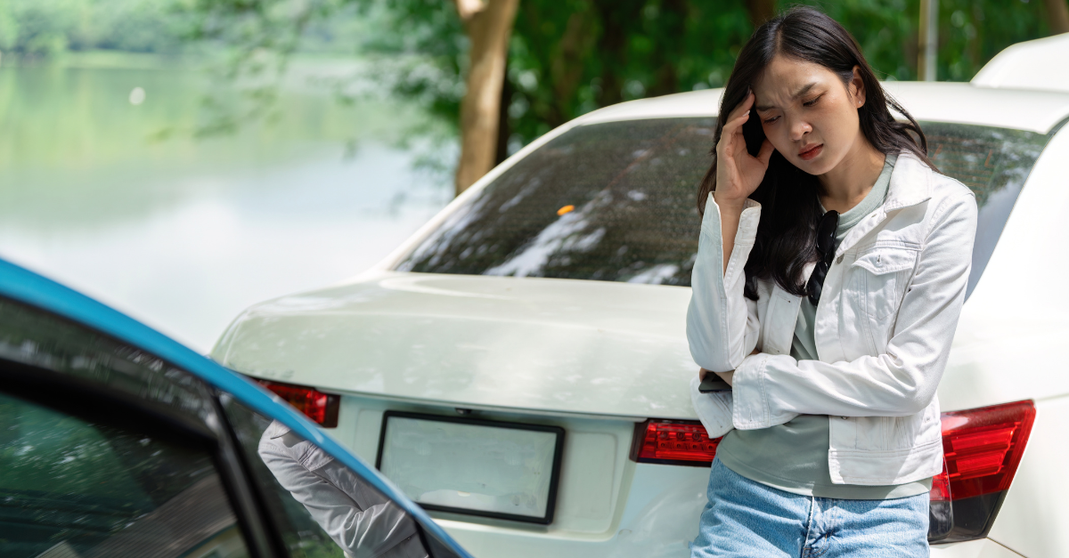 Insurance Stress. A woman looking worried after a car accident, waiting for assistance.