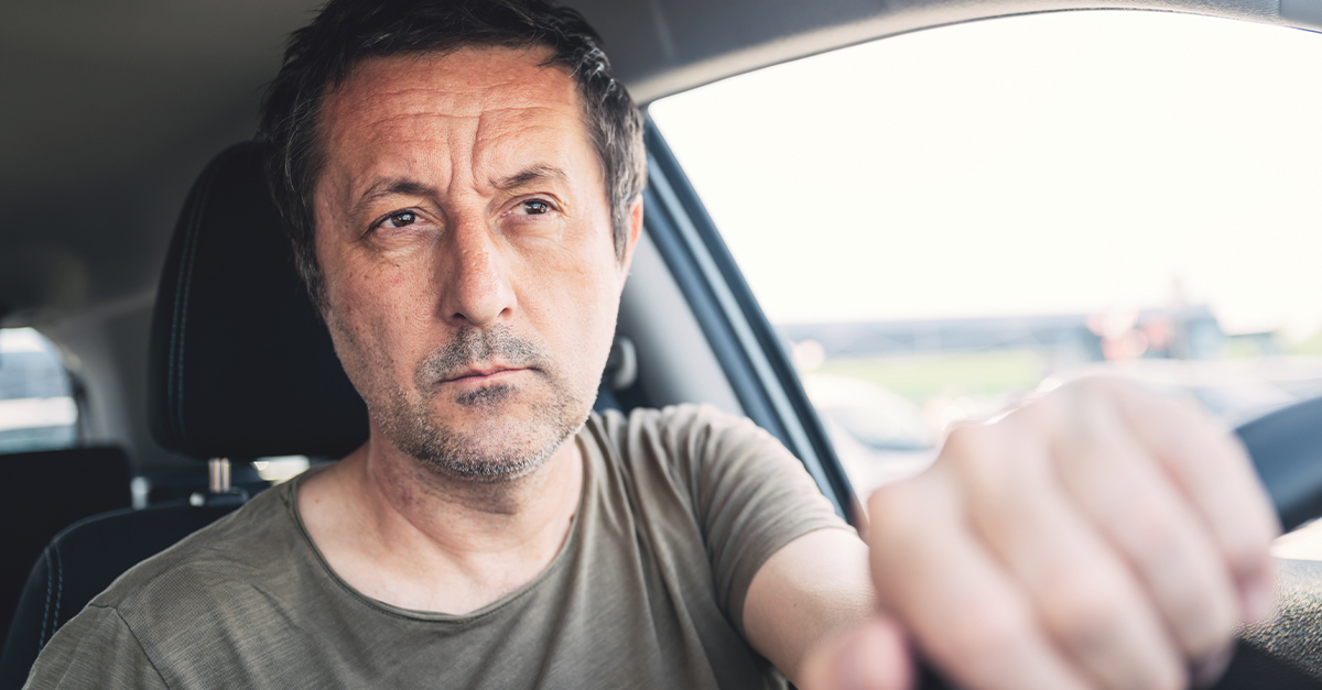 Middle-aged man driving.