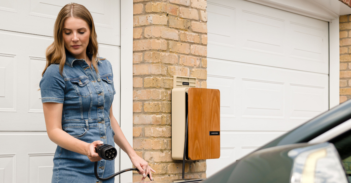 young-woman-using-an-andersen-domestic-ev-charge-point-to-charge-a-fully-electric-kia-niro-ev-at-home