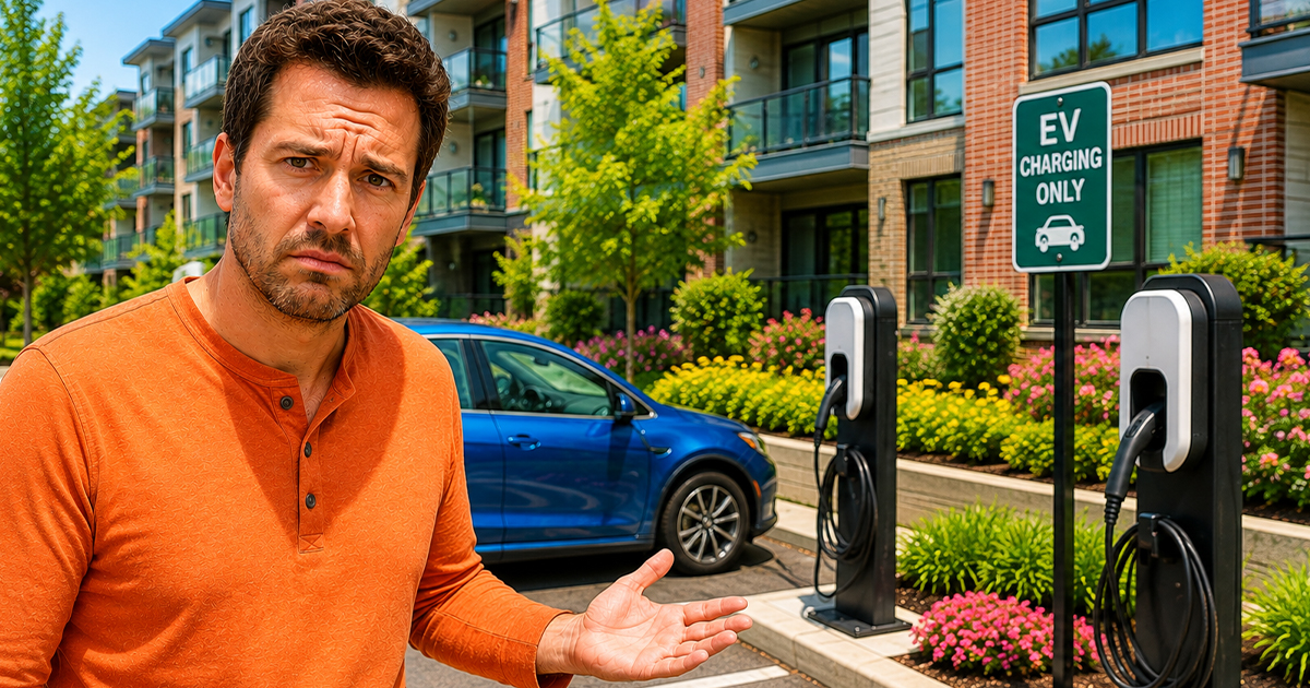 Concerned man standing beside an EV charger
