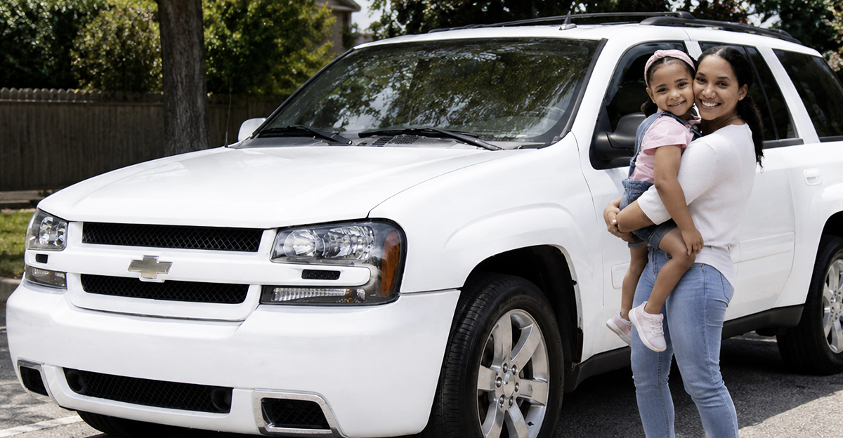 Modified image of a woman holding a child, with a A 2006 Chevrolet Trailblazer SS.