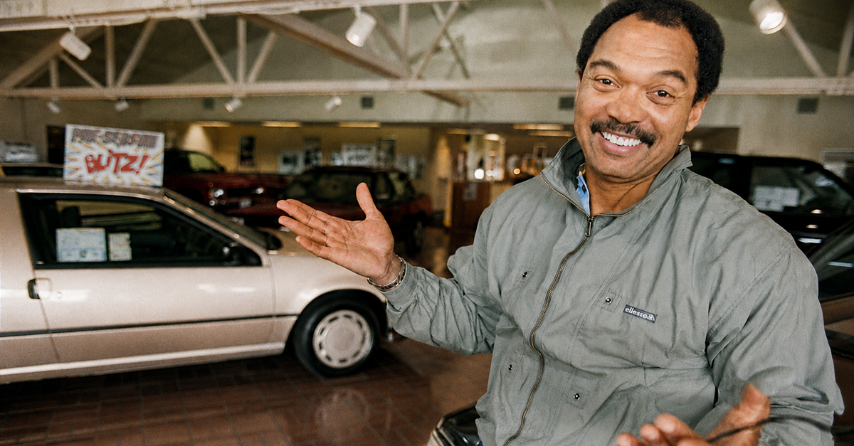 Portrait of American retired baseball player Reggie Jackson as he poses in his recently-purchased Nissan car dealership , Palo Alto, California, October 7, 1987