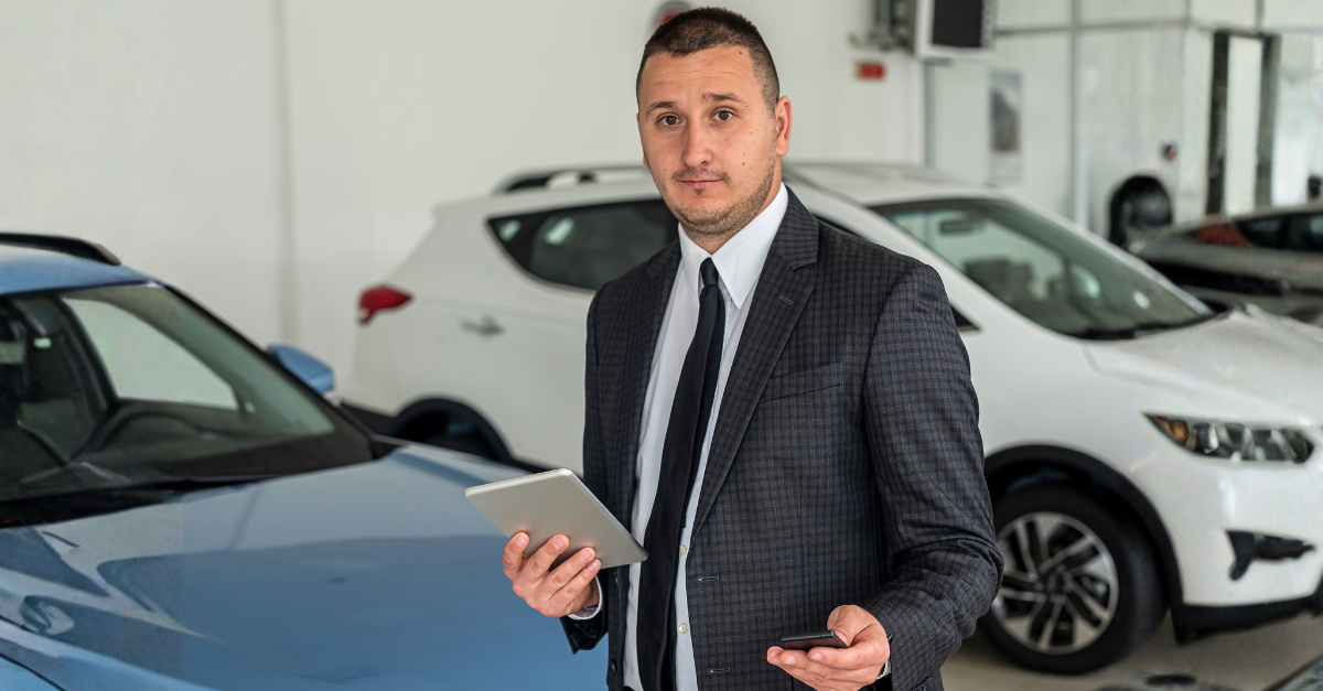 Satisfied happy young male customer choosing new car at showroom or dealership. vehicle sale concept
