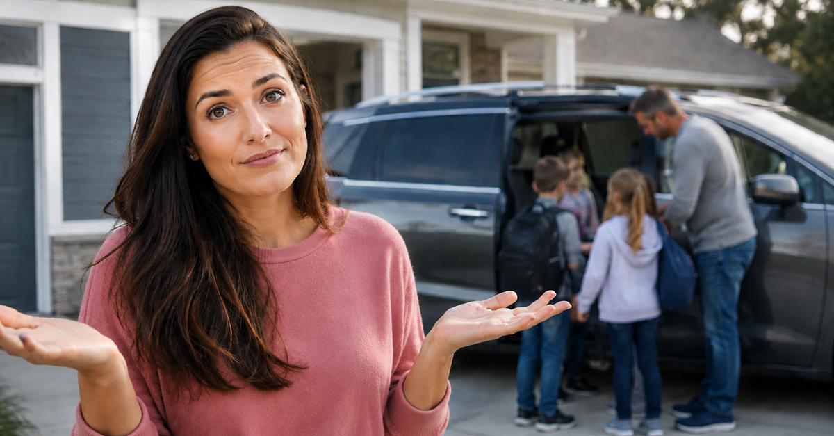 Woman with arms raised, standing beside minivan